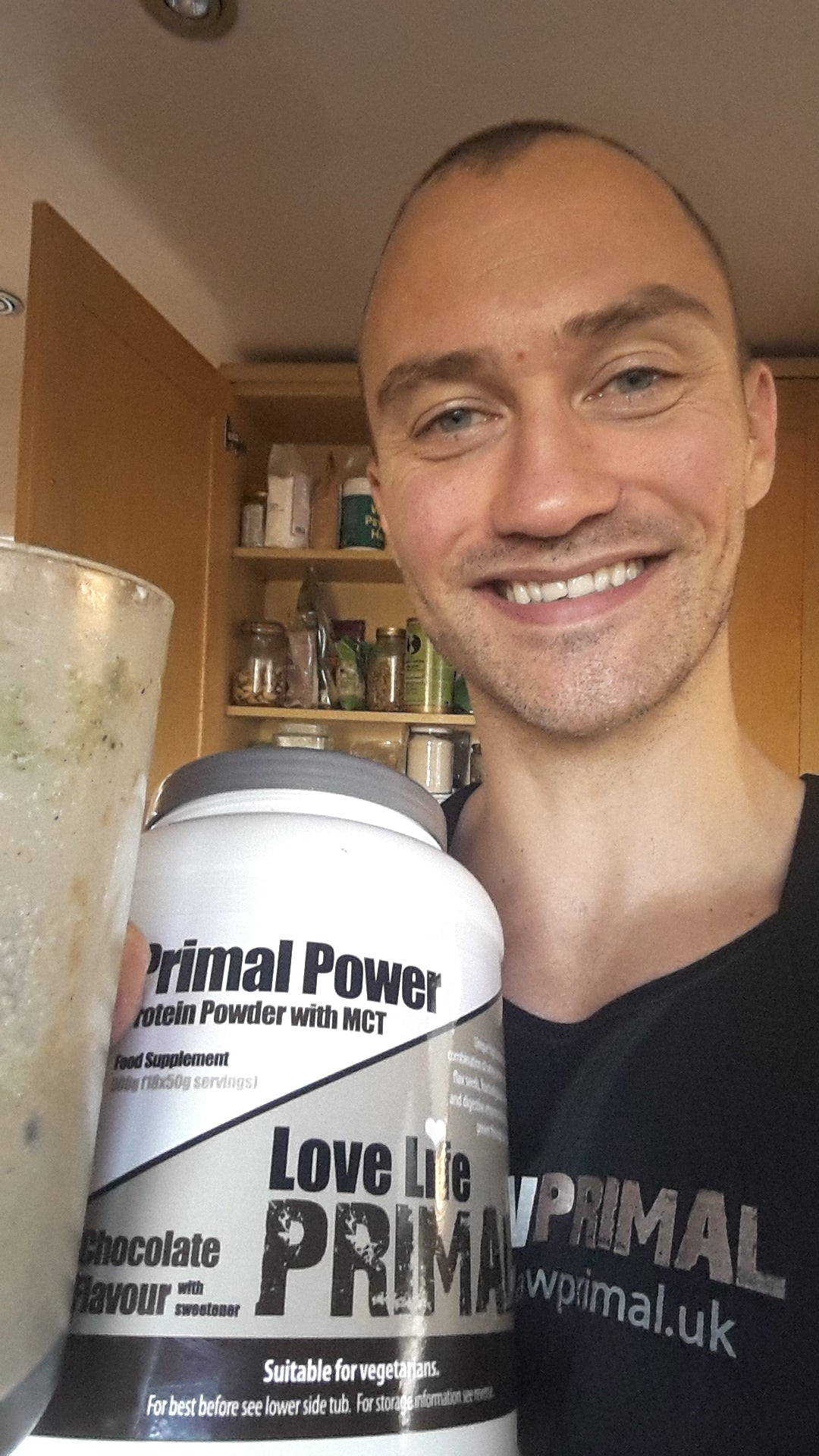 ben law primal power Person holding a container of Primal Power protein powder