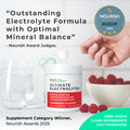Supplement container labeled 'Ultimate Electrolytes' with a hand holding a glass of water and a bowl of raspberries, on a white background.