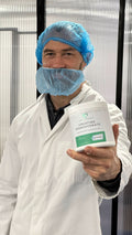ben law Person in a lab setting holding a container labeled 'Creatine Monohydrate'.